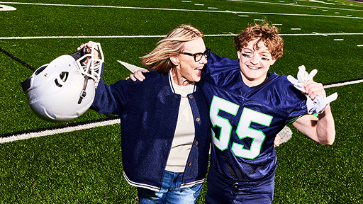 Jace on the football field with Mom Holly